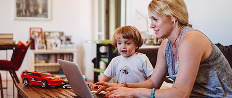A mother and son scheduling a medical appointment on a tablet device.