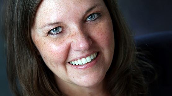 iHeart Radio host Bonnie Diver smiling and looking into the camera.
