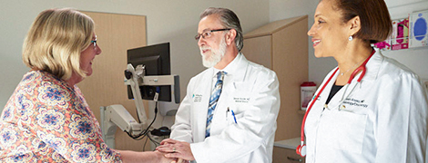 A doctor shaking hands with a patient.