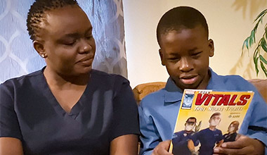 Nurse looking at the Marvel's graphic novel The Vitals - True Nurse Stories together.